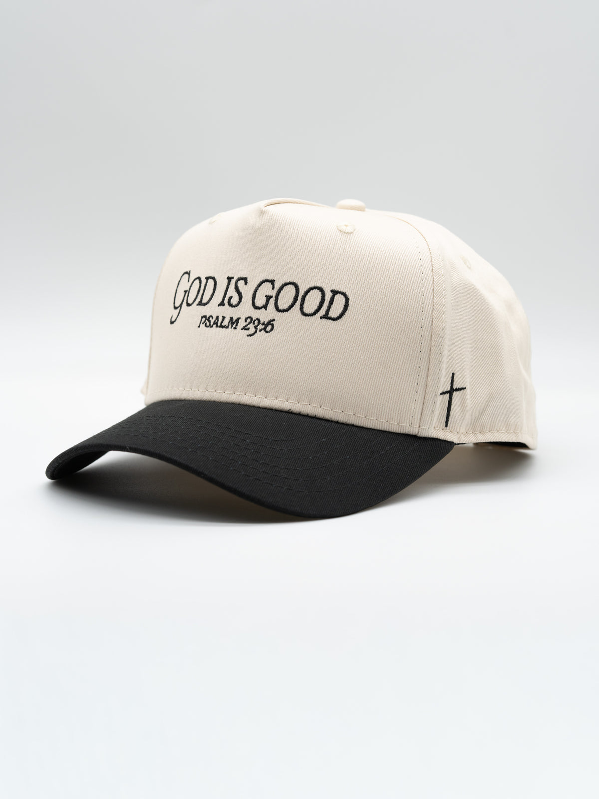 Premium Embroidered Hat featuring God Is Good and Psalm 34 8 embroidery on a cream five panel cap with black brim and cross detail for faith based apparel
