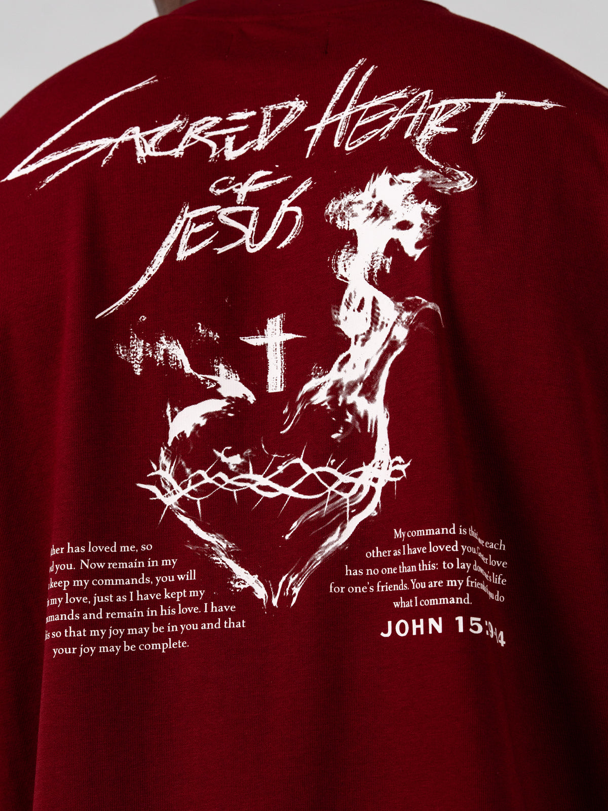 Sacred Heart Premium Oversized Tee in red featuring a white Sacred Heart of Jesus graphic with cross crown of thorns and John 15 verse artwork