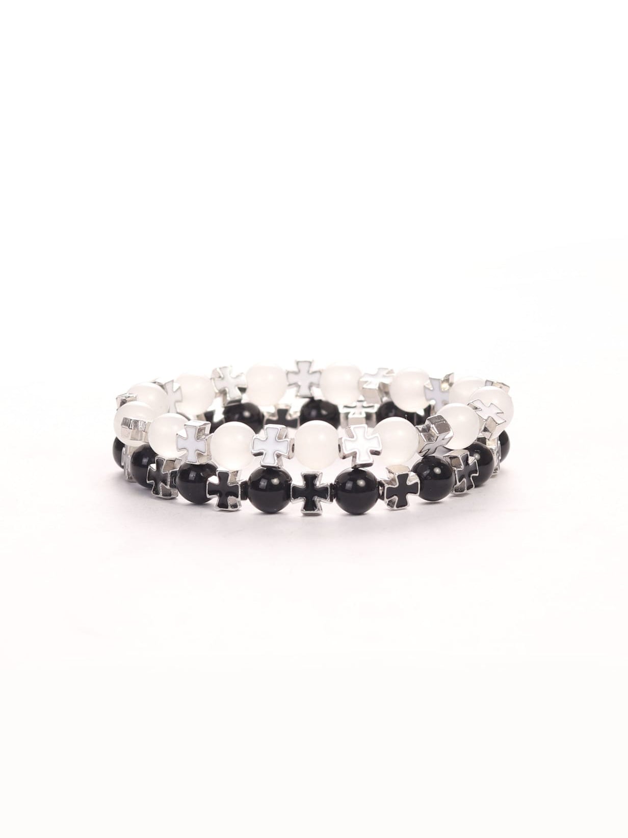 Close-up of two beaded bracelets with alternating black and white beads and silver cross charms, designed as the Cross Wristband Pack for faith-based fitness apparel.