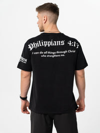 Person wearing a black t-shirt with 'Philippians 4:13' text on the back.