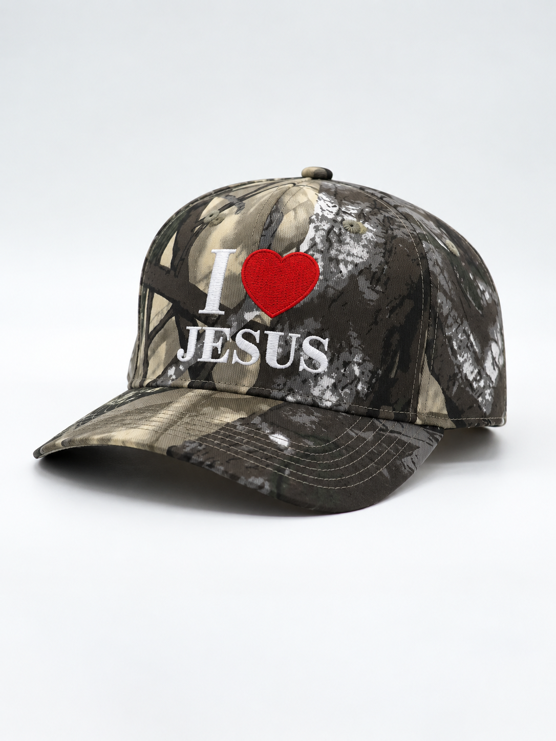 Premium Embroidered Hat featuring a camouflage five panel design with white I love Jesus lettering and red heart embroidery on the front and a curved brim